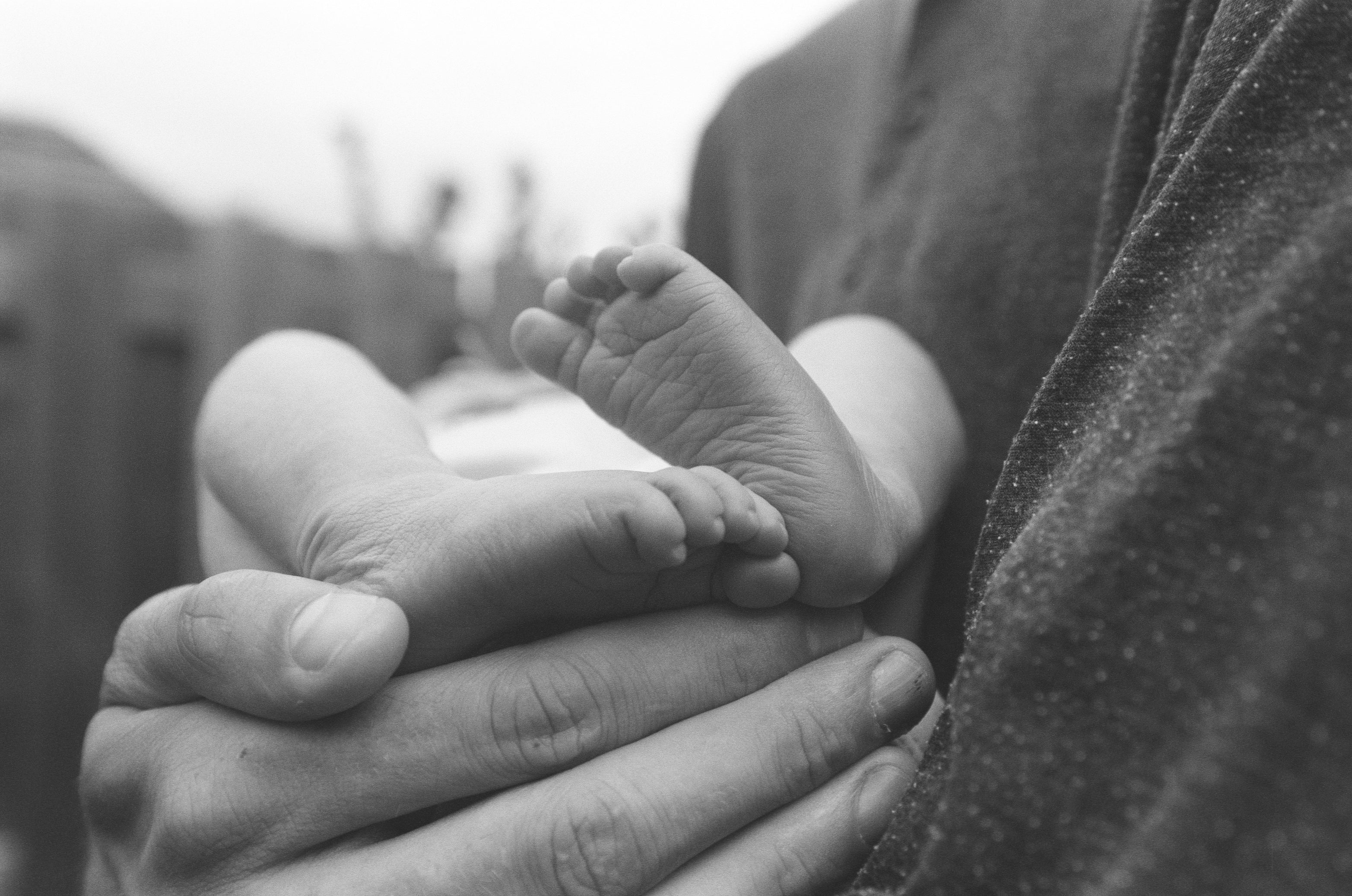 files/a-mans-large-hand-cradles-a-newborn-baby.jpg