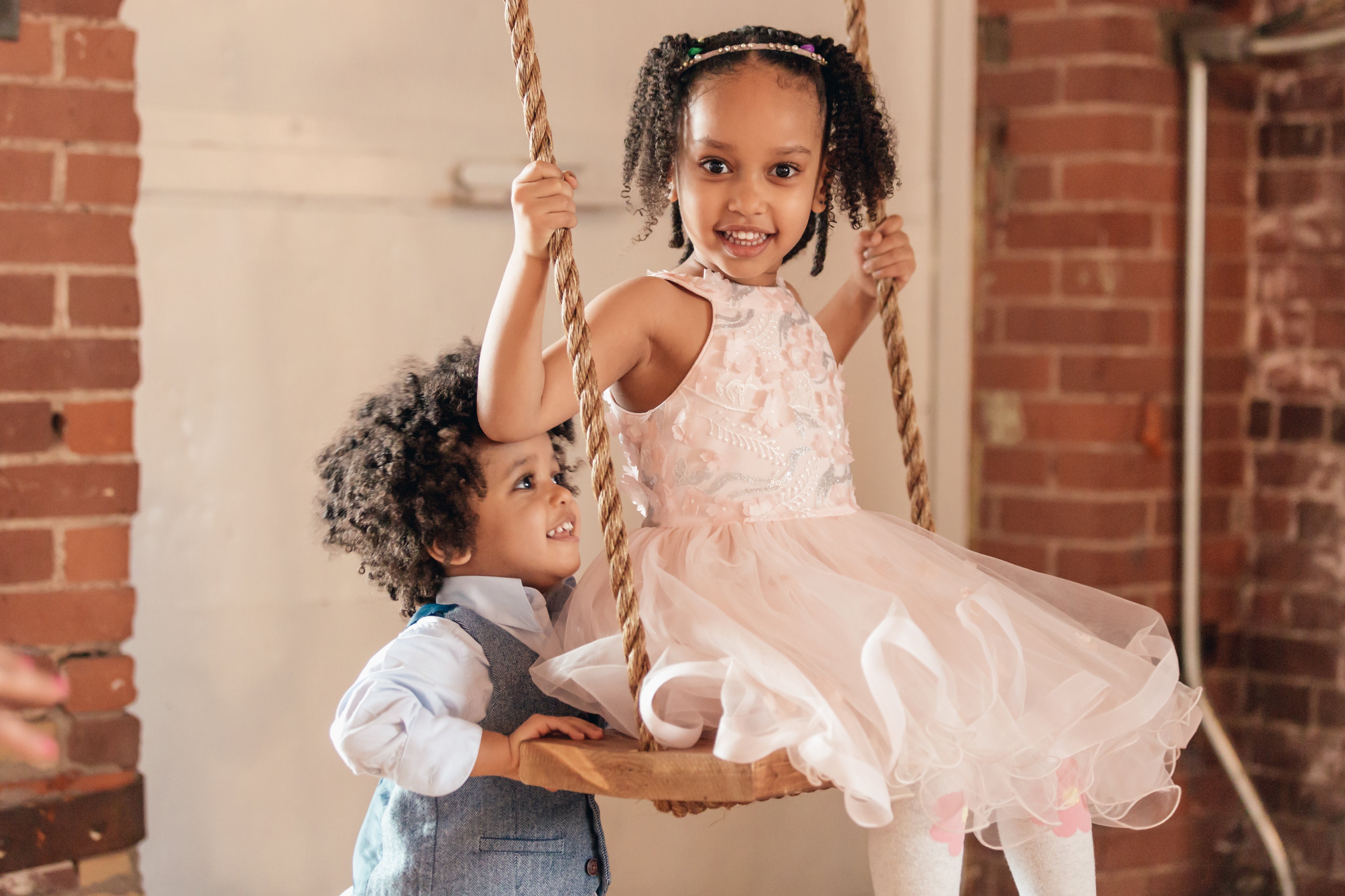 files/young-boy-pushes-sister-on-swing.jpg